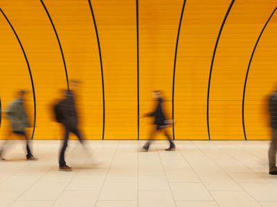 A Futuristic Orange Subway Station Corridor With Motion Blurred Commuters At Rush Hour Copy