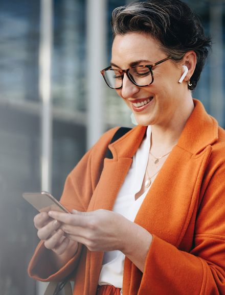 happy person looking at mobile phone